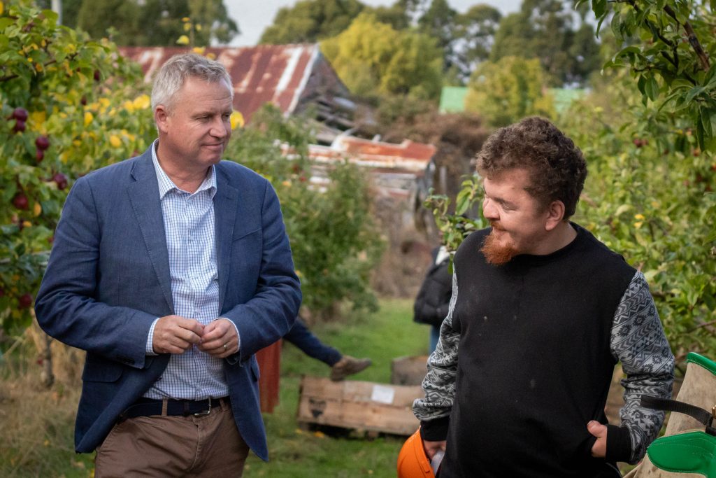 Premier, Jeremy Rockliff MP meets with SEED team member, Clayton, at our orchard in Franklin