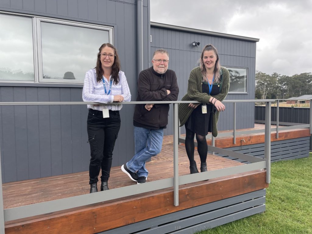 Three Nexus staff standing outside the supported independent living home in Kingston.