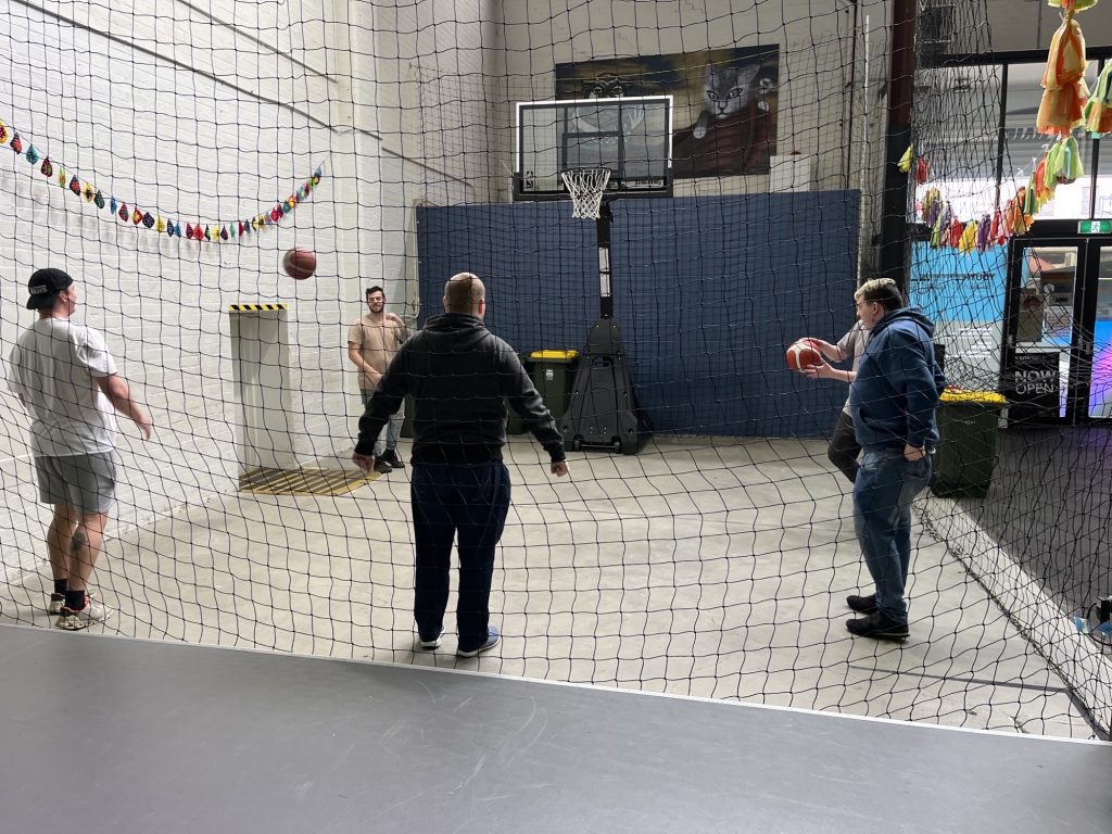 Clients and support workers from the Nexus Community Services team having a great time playing basketball at Youth ARC.