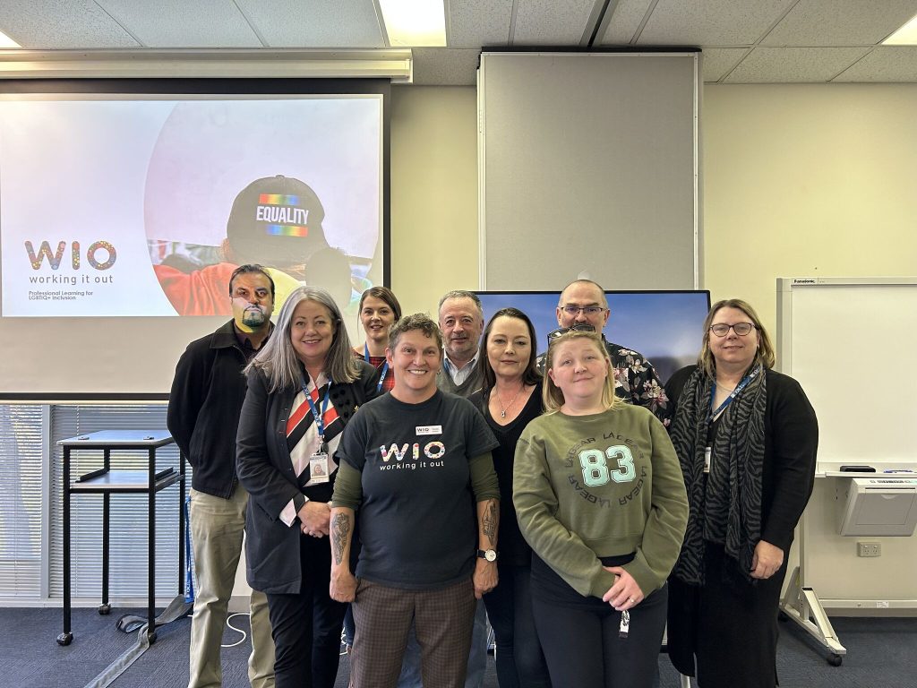 A group of Nexus staff members smile at the camera after attending an Inclusion Training session through LGBTIQ+ advocacy and education organisation Working It Out. 